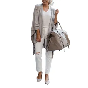Detailed view of women's gray knit cardigan with loose fit and stylish irregular hem