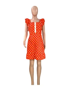 Detail view of red polka dot mini dress with ruffle sleeves and button accents