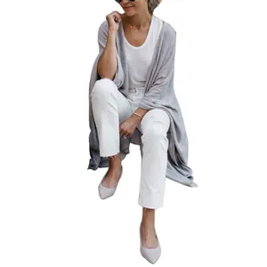 Close-up of grey oversized knit cardigan with irregular hem and casual drape