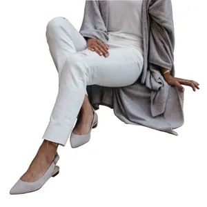 Detailed view of a long grey knitted cardigan with an asymmetric hem and loose fit.