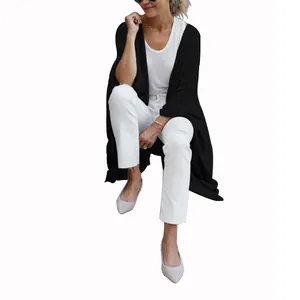 Close-up of women's black knit cardigan featuring an irregular hem and a relaxed loose fit