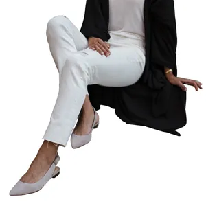 Detail of a loose black mid-length knitted cardigan with an irregular hem design