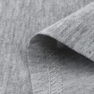 Close-up view of grey knitted fabric texture and durable overlock stitching detail.