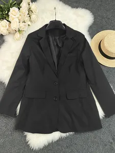 Detailed view of classic black women's blazer on white faux fur with floral accents