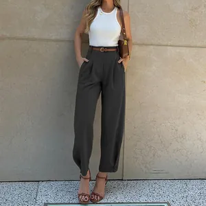 Full body view of stylish grey high-waisted suit trousers styled with a white top