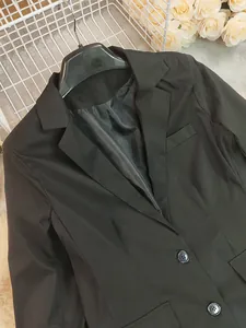 Detailed view of a classic black blazer for women with notch lapel and black buttons