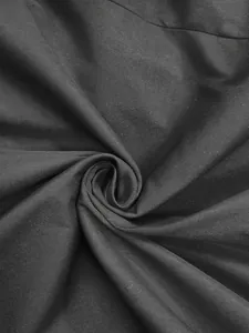 Macro close-up showing the smooth texture and drape of black blazer suit fabric