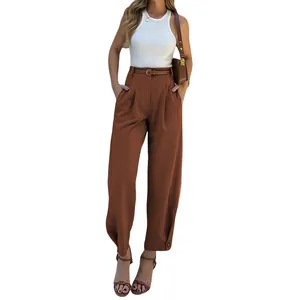 Model wearing high-waisted brown tailored trousers with a matching belt