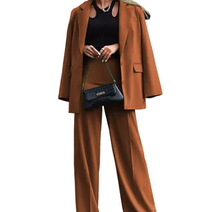 Detail of a burnt orange two-piece suit set featuring a blazer and wide-leg trousers.