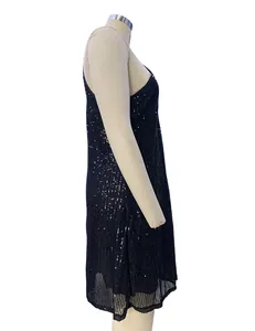 Side view detail of an elegant black sequined halter neck cocktail dress on a mannequin