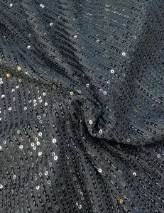 Detailed macro view showing shimmering silver sequins on premium charcoal grey mesh fabric