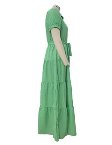Detailed side view of green and white striped short sleeve tiered maxi dress with belt