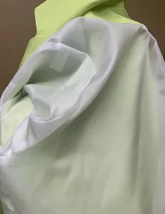 Detailed macro view showing inner lining and stitching of neon green casual blazer jacket
