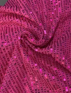 Close-up of hot pink sequin fabric detail showing high-quality embroidery texture
