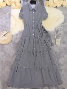 Full-length view of a black and white striped short sleeve shirt dress with tiered skirt