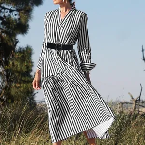 Elegant black and white vertical striped long sleeve midi dress with a stylish V-neck cut.
