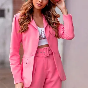Detail shot of fashionable pink long-sleeve blazer and matching trouser suit with belt