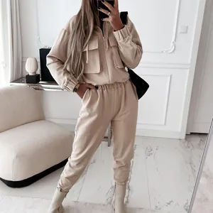 Modern beige women's two-piece tracksuit featuring a zip-up hoodie and joggers set