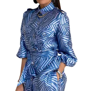 Detailed view of blue palm leaf print shirt set with lantern sleeves and tie belt