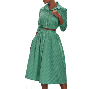 Close-up detail of green and white vertical striped two-piece shirt and midi skirt set
