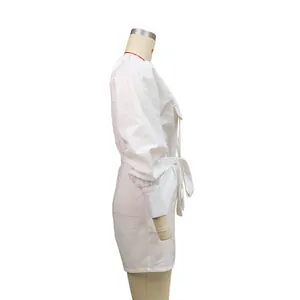 Detailed side view of white cotton linen romper featuring puff sleeves and waist belt detail