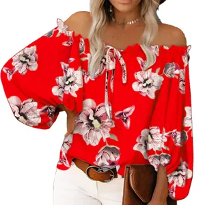 Detail shot of red off-the-shoulder blouse with elegant pink floral print and tie neck.