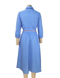Back view of a blue and white vertical striped two-piece set with long sleeves and midi skirt