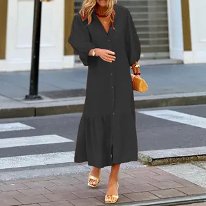 Fashionable loose black puff sleeve midi dress with button detail for casual resort style