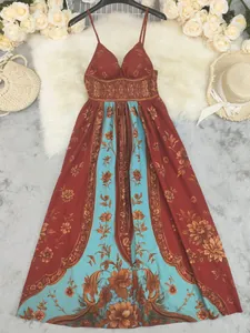Bohemian floral maxi dress with spaghetti straps shown with resort-style accessories.