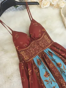 Detail view of vintage floral print maxi dress with spaghetti straps and boho style.