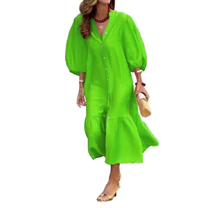 Close-up of vibrant green midi dress featuring puff sleeves and button-down front