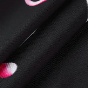 Macro detail of breathable black fabric with pink and white skeleton print pattern.