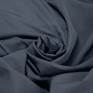Macro view of dark charcoal grey matte fabric texture for mid-length vacation dress