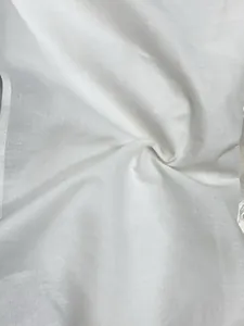 Macro detail of breathable white cotton linen fabric texture showing weave pattern