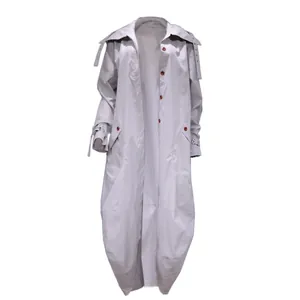 Detail view of light grey long trench coat featuring large lapel and oversized fit