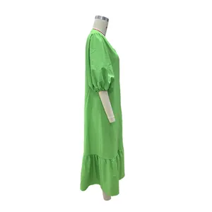 Side profile of a loose lime green puff sleeve midi dress with ruffled hem details
