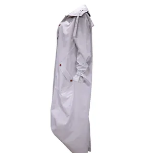Side view of a women's long light grey trench coat with unique large lapel design