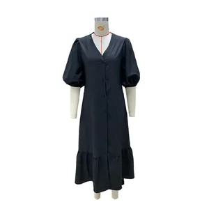Detailed shot of black midi dress featuring puff sleeves and a V-neck button-down front