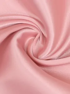 Detailed macro view showing the smooth texture and elegant sheen of pink satin fabric