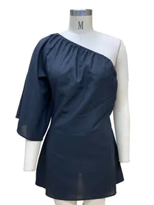 Close-up view of a black one-shoulder loose cotton linen dress on white mannequin.