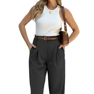 Close-up detail of high waisted black wide leg trousers with a brown leather belt