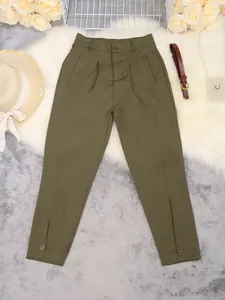 Detail of olive green high-waisted pleated trousers with decorative buttoned hem accents