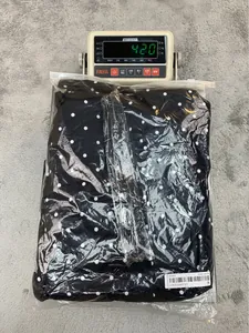Weight measurement of black polka dot lapel blazer showing 420 grams on scale
