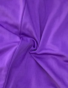 Detailed macro view showing the soft purple fabric texture of a summer jumpsuit