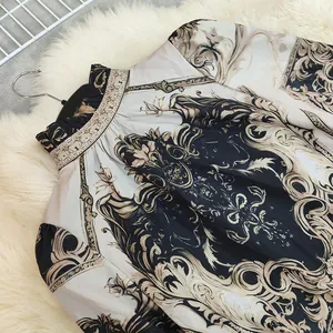 Detail of French retro palace style shirt with elegant baroque gold print and stand collar
