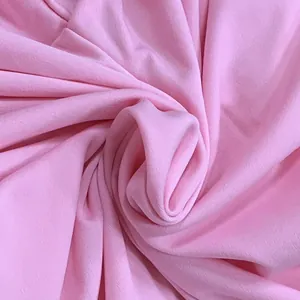 Soft pink fabric texture detail of a stylish summer one-shoulder jumpsuit