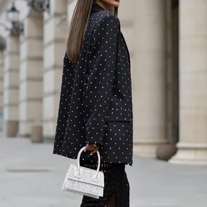 Side view of elegant black polka dot blazer with lapels and long sleeves for women