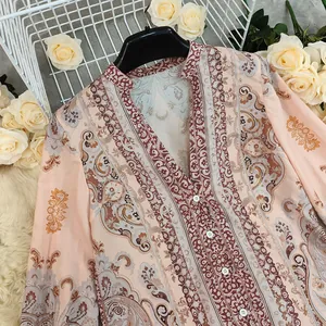 Detail view of Bohemian printed loose V-neck blouse with elegant floral patterns