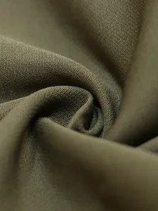 Detailed macro shot of premium olive green fabric showing twill weave and soft texture