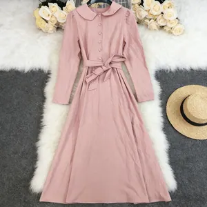 Pink long-sleeved cotton linen maxi dress featuring a Peter Pan collar and waist tie